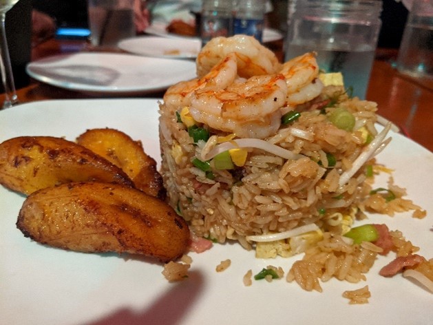 A dish with fried rice, shrimps, and bananas